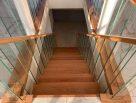 Steel staircase with timber treads and glass balustrades